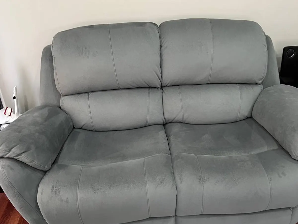 A grey two-seater sofa cleaned by hot-water extraction