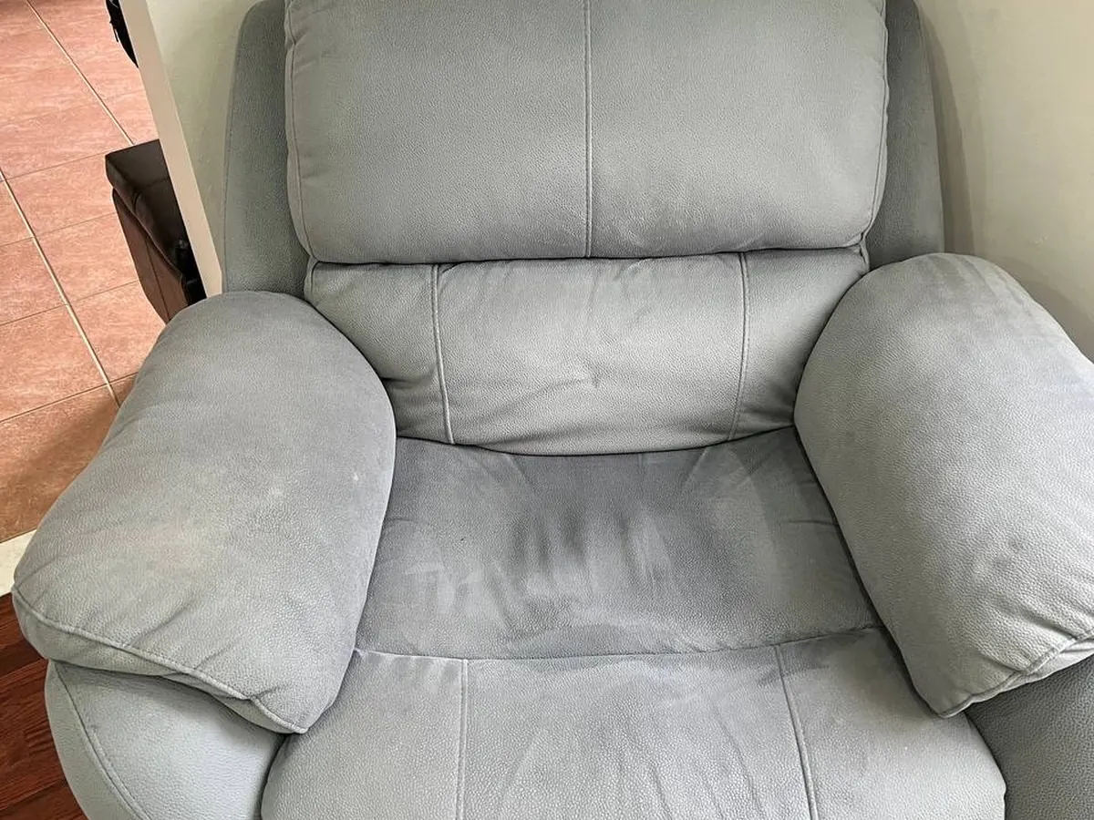 A fabric recliner armchair after cleaning